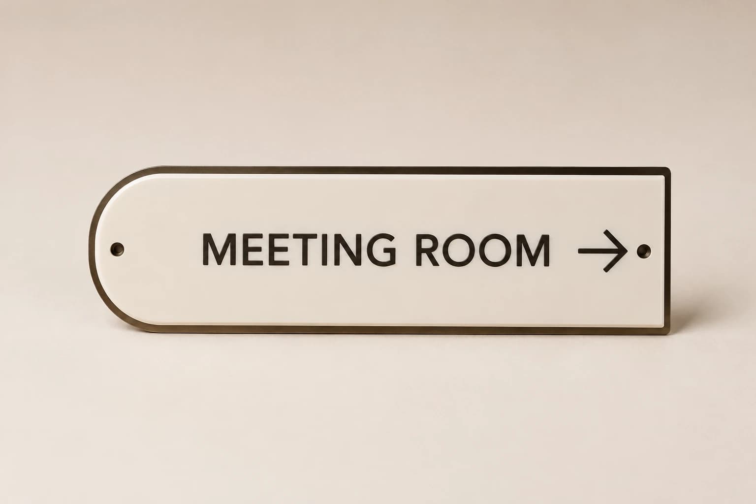 Layered ivory and bronze meeting-room direction sign.